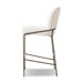 Light fabric bar stool from side; curved backrest, padded seat, and horizontal footrest bar