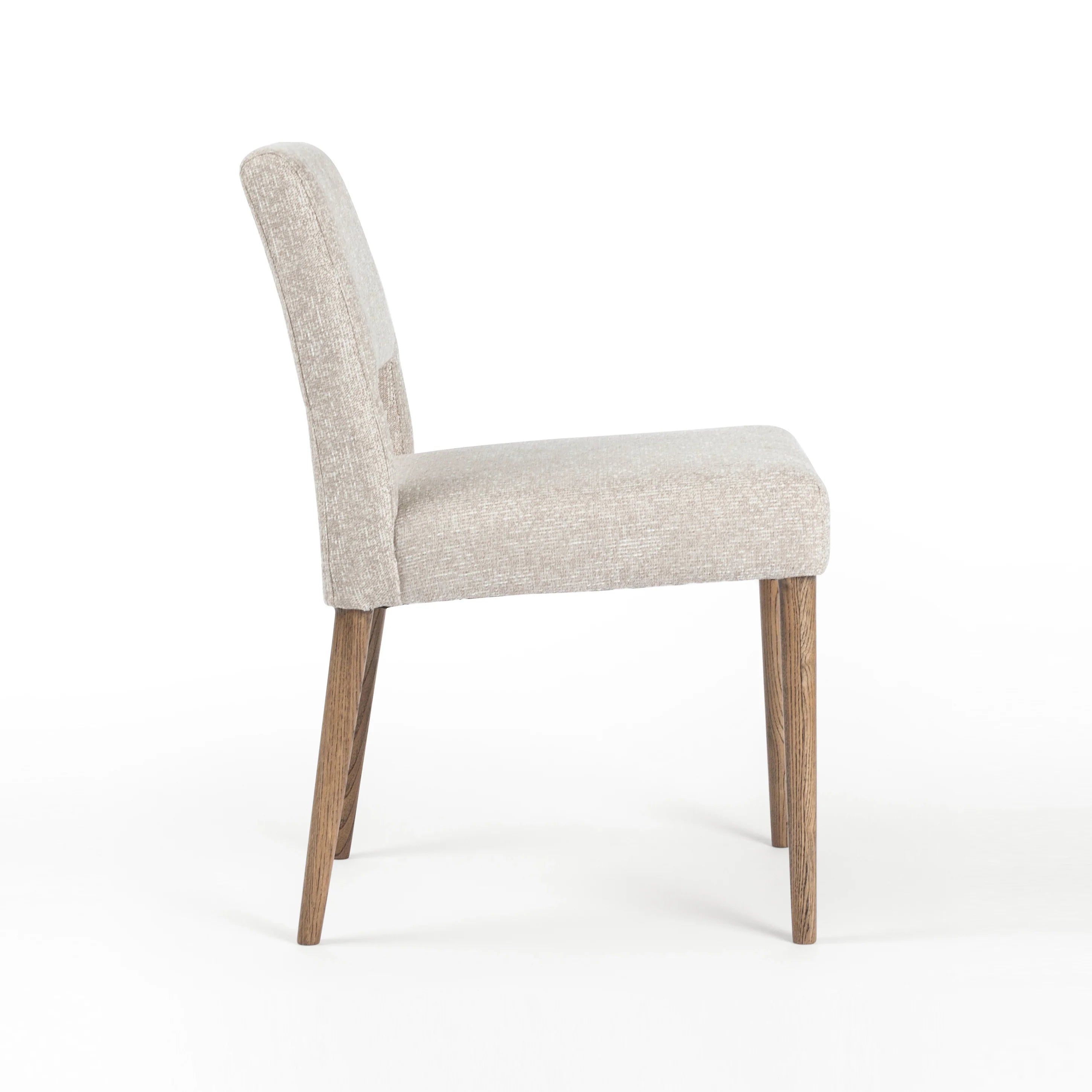Armless dining chair side view with light camel upholstered back and seat, wooden legs.