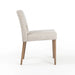Armless dining chair side view with light camel upholstered back and seat, wooden legs.