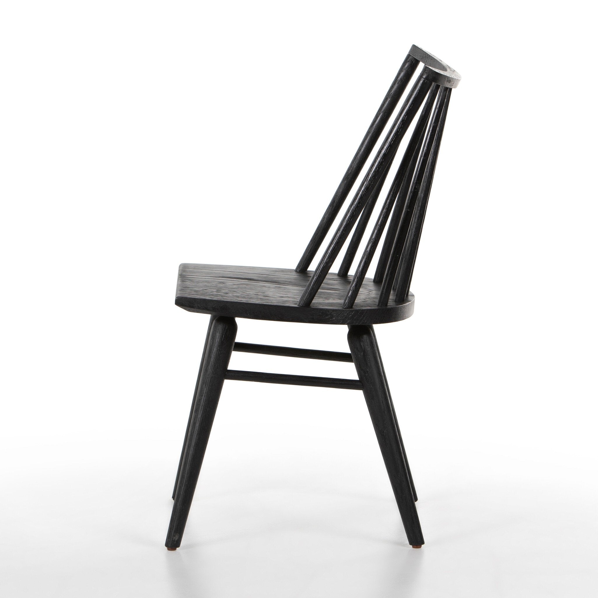 Black armless dining chair side view with slatted back, smooth dark wood seat, tapered legs