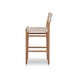 Outdoor bar counter stool from side view with vintage white woven seat and wood frame