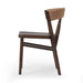 Side view A solid oak dining chair with a paper rush wrapped detail on the back, tapered legs, and a dark finish.