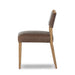Brown armless dining chair side view with upholstered seat and back, wood frame.