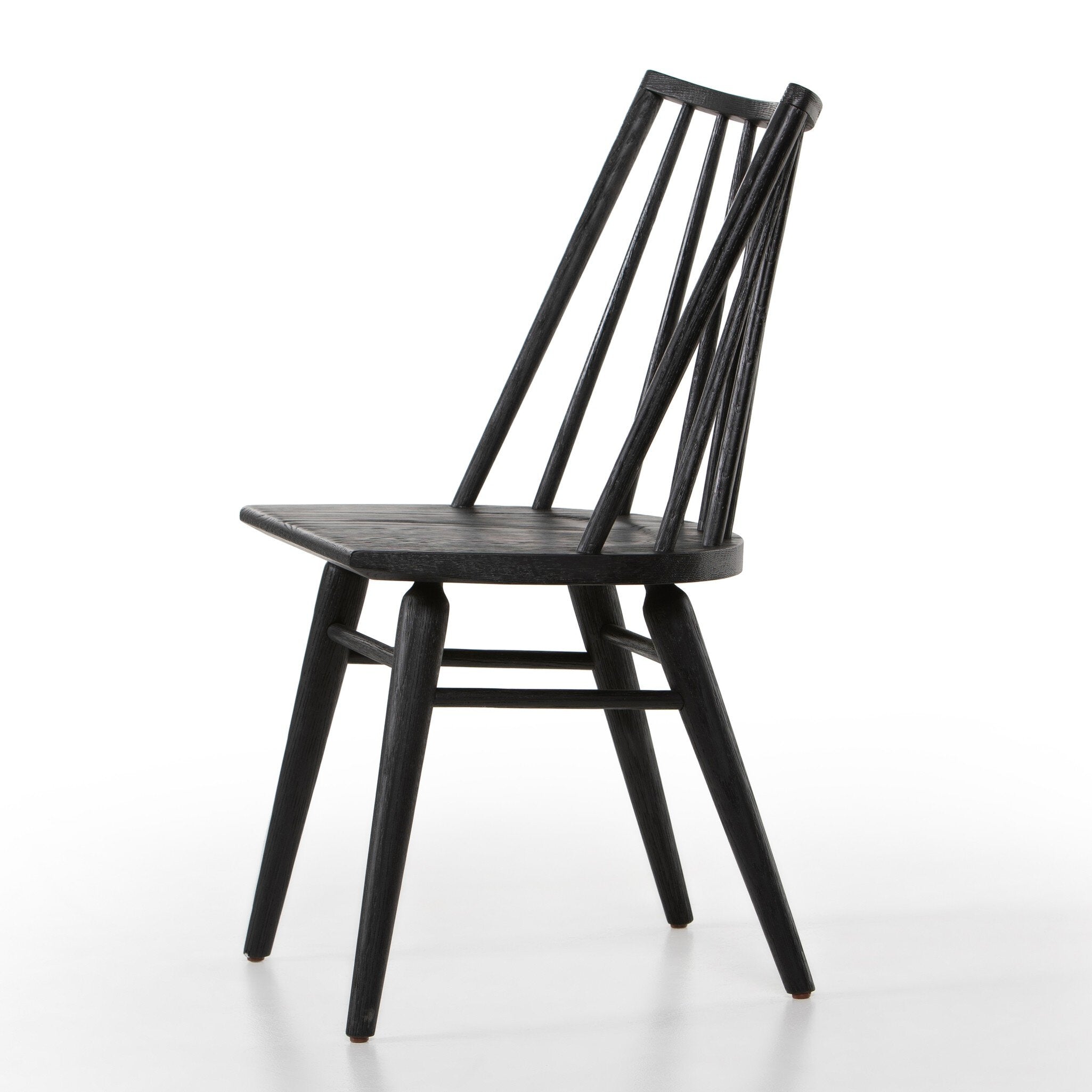 Black armless dining chair angled view with slatted back and dark wood seat, curved rails