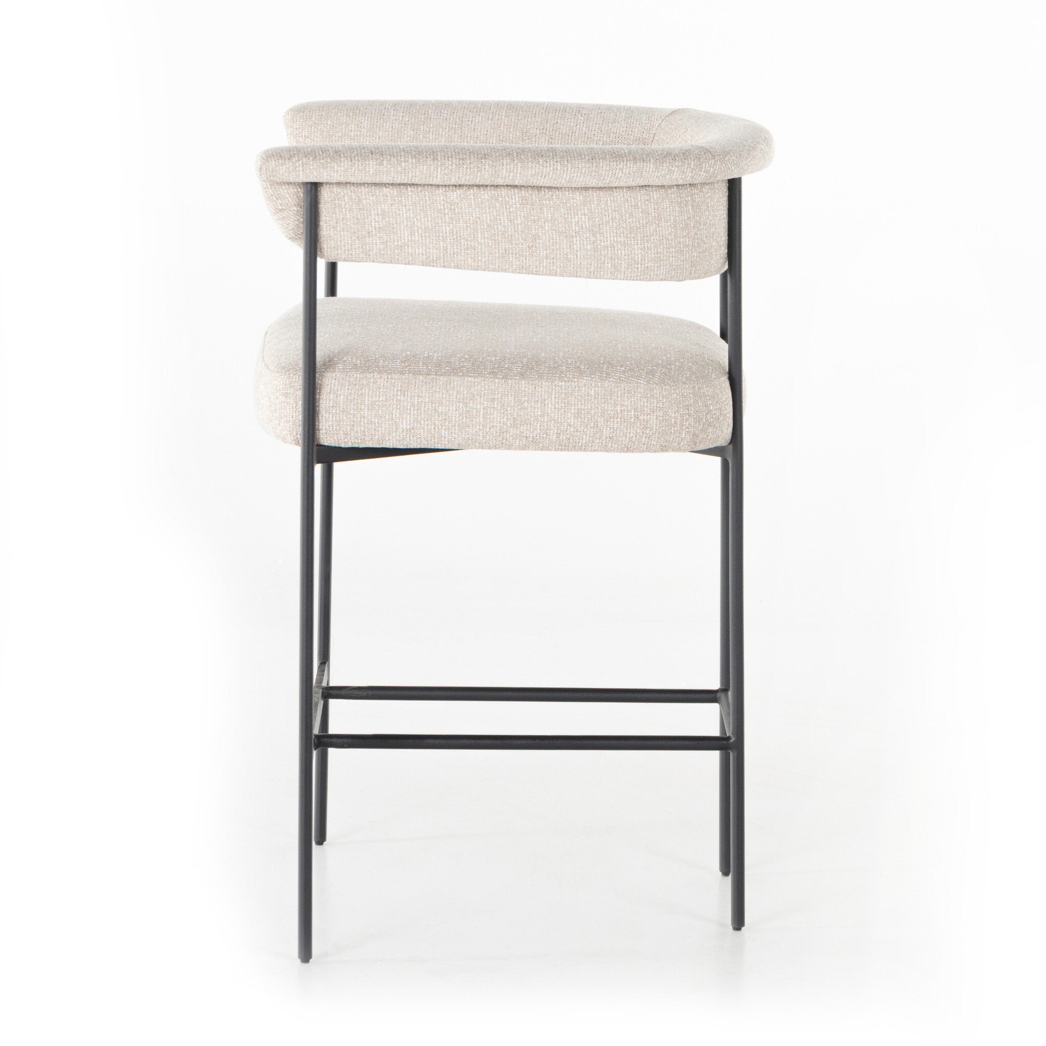 Upholstered counter stool with light camel fabric seat and back pad; black metal frame