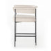 Upholstered counter stool with light camel fabric seat and back pad; black metal frame