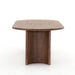 Side view Paden Dining Table in Seasoned Brown Acacia with crescent-shaped legs and an oval tabletop