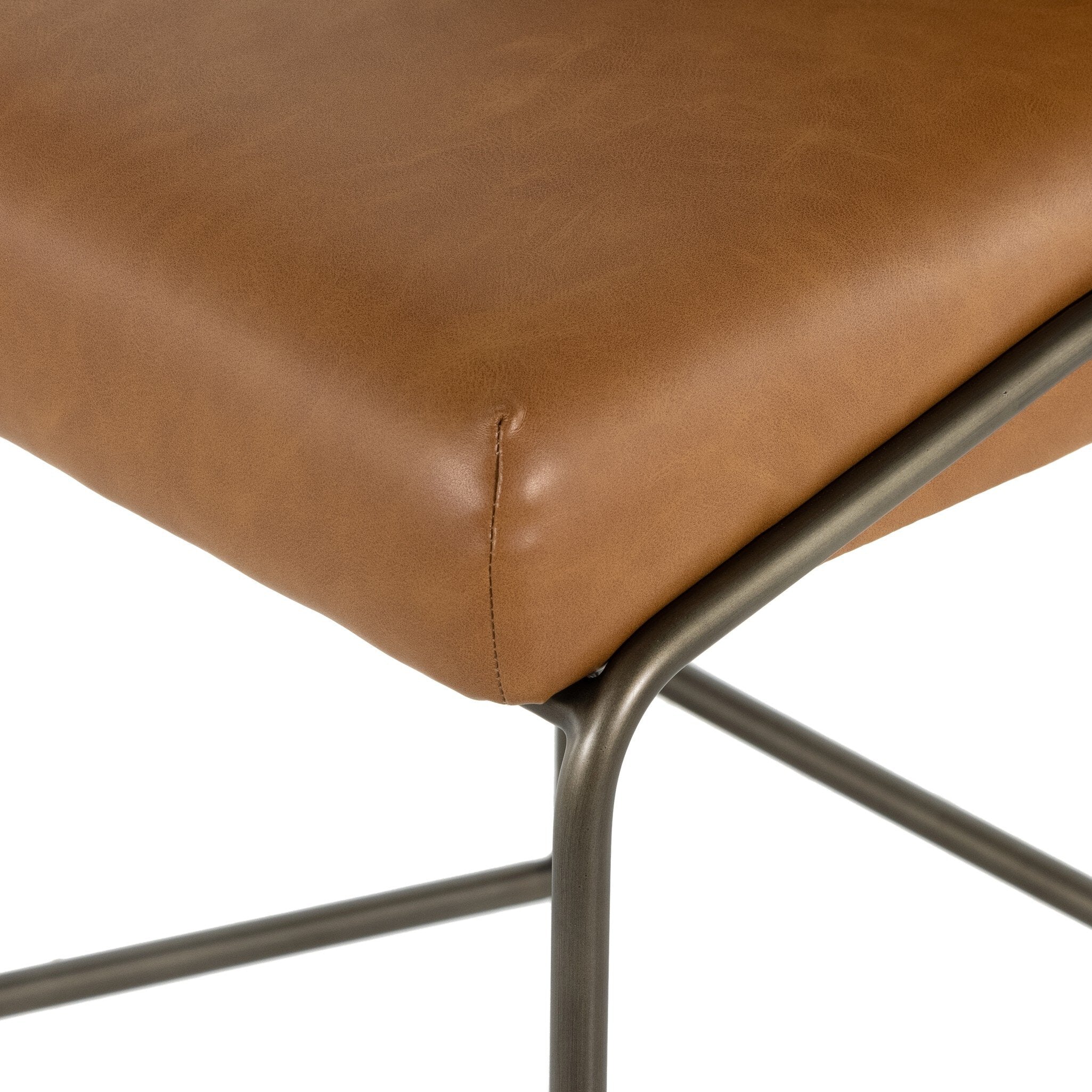 Brown bar stool seat with rounded corner seam and dark metal frame legs