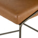 Brown bar stool seat with rounded corner seam and dark metal frame legs
