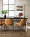 Pair of brown bar stools with padded seats, arched backs, and black metal frames.