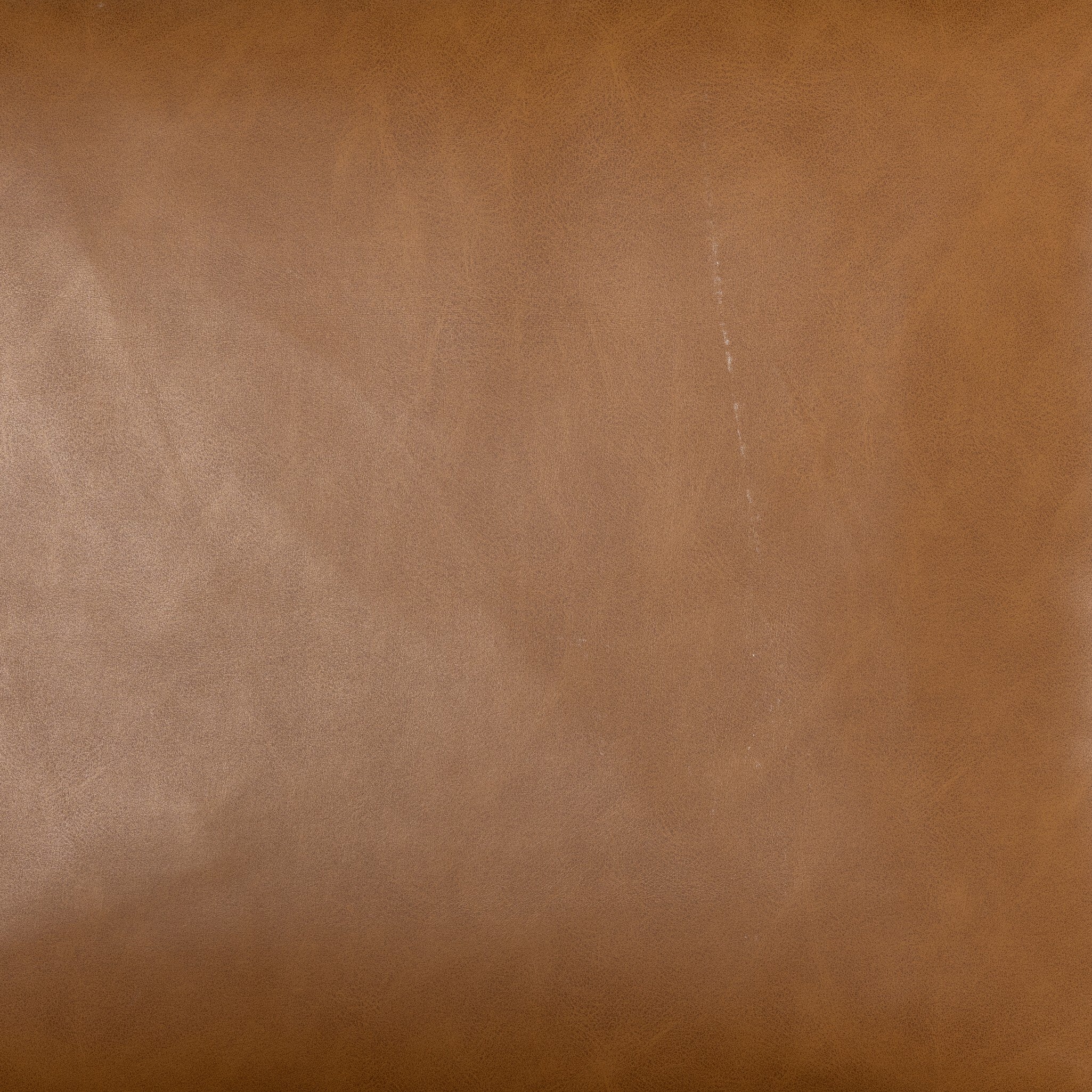 Close-up of tan leather-look counter stool upholstery texture with visible grain