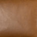Close-up of tan leather-look counter stool upholstery texture with visible grain