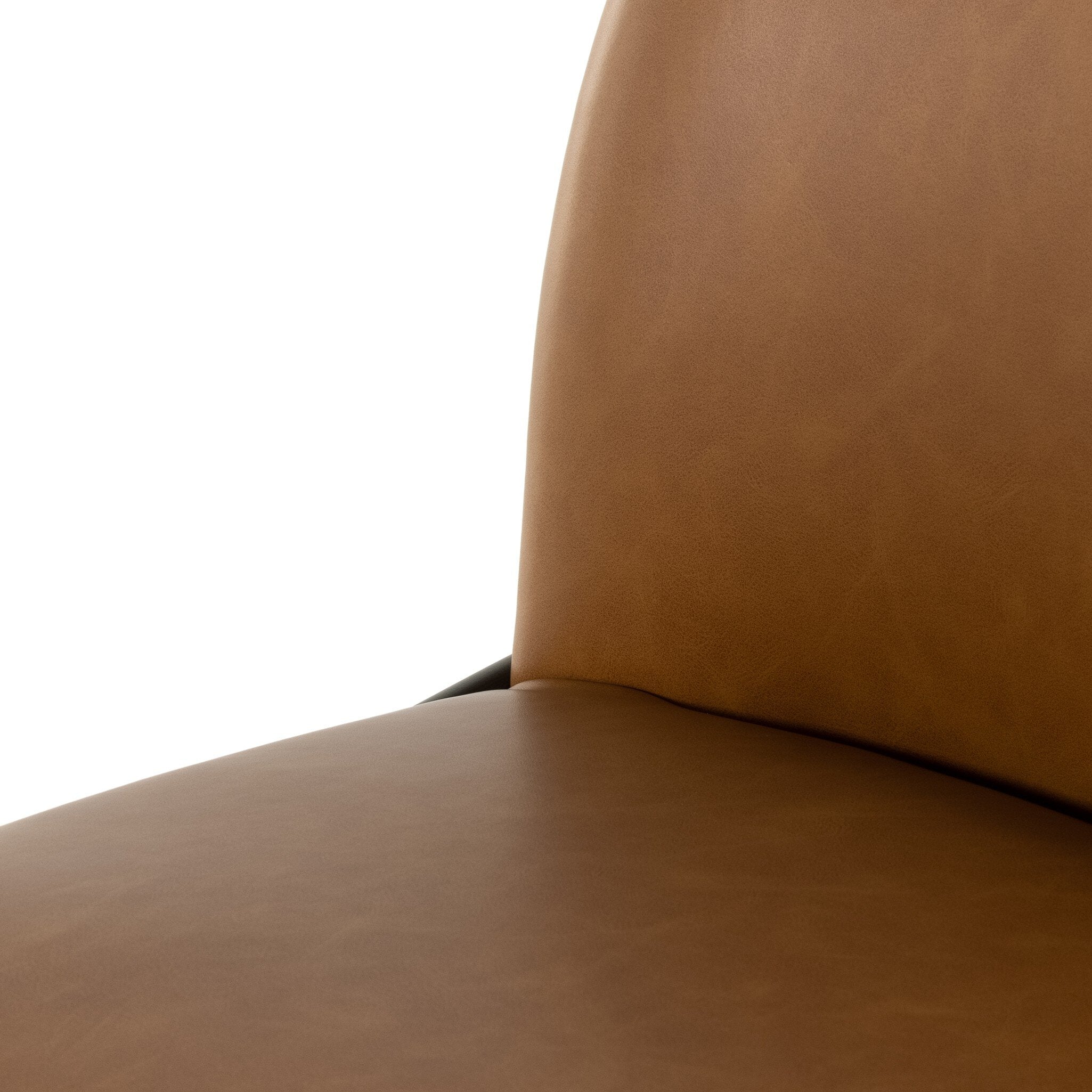 Close-up of brown padded seat and back cushion with visible seam.