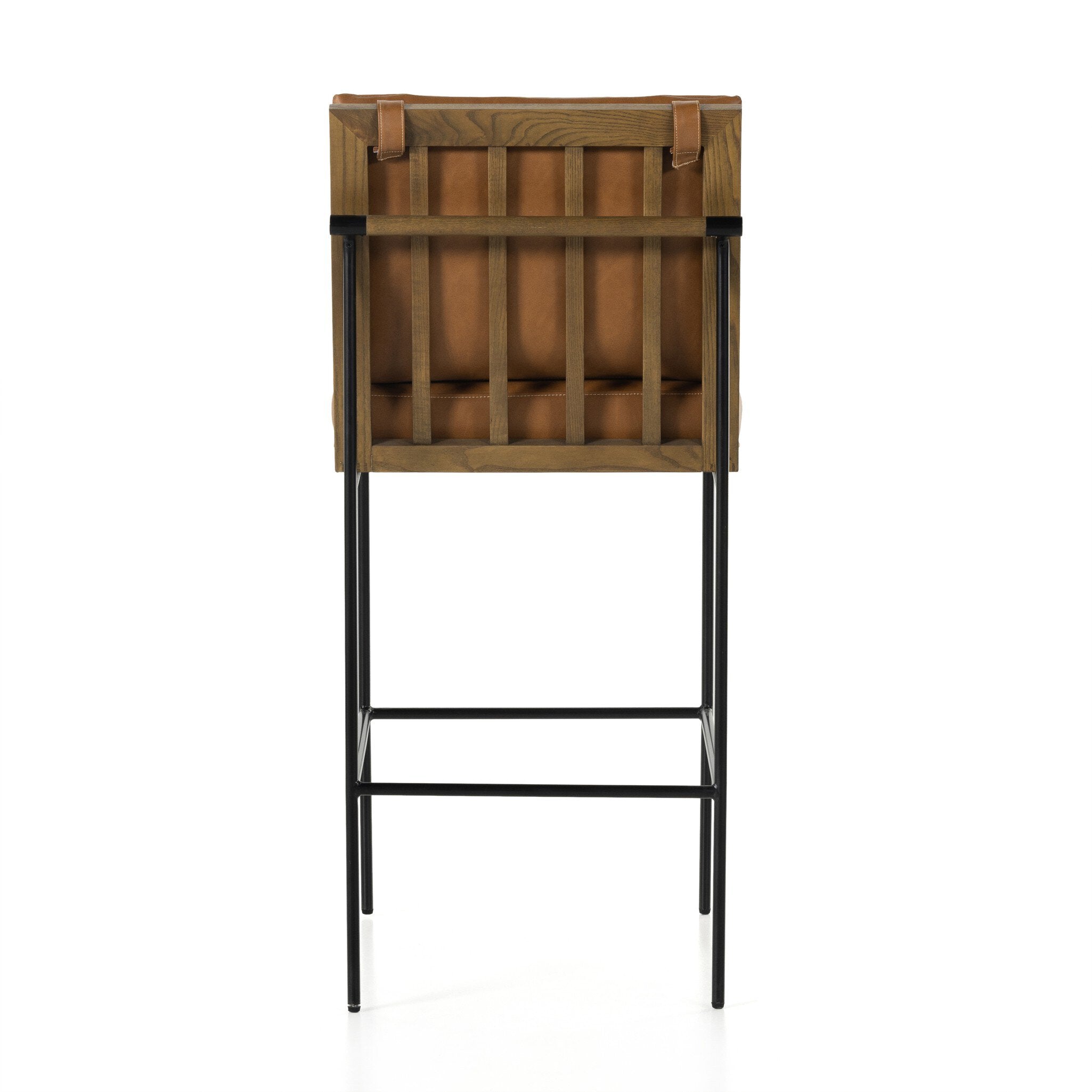 Crete bar stool rear view with tan upholstery and black base with footrest