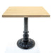 Square table with a wooden top and decorative metal pedestal base on a white background