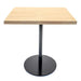 Square table with wooden top and black round base on a white background