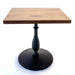 Square wooden table with a black metal base on a white background