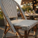 Nautilus side chair seat detail with gray-and-white woven pattern and wood frame