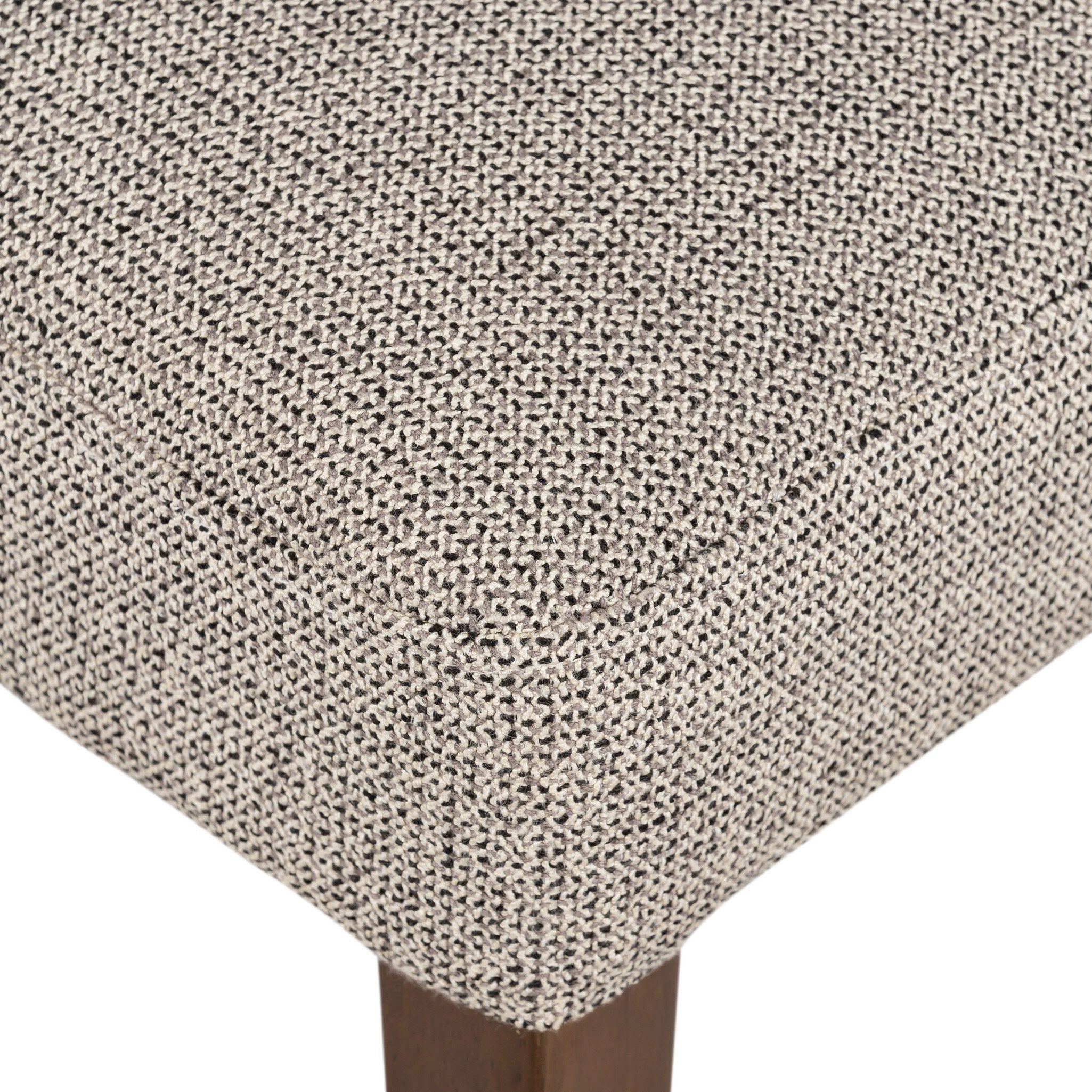 Armless dining chair seat cushion close-up in beige textured woven upholstery