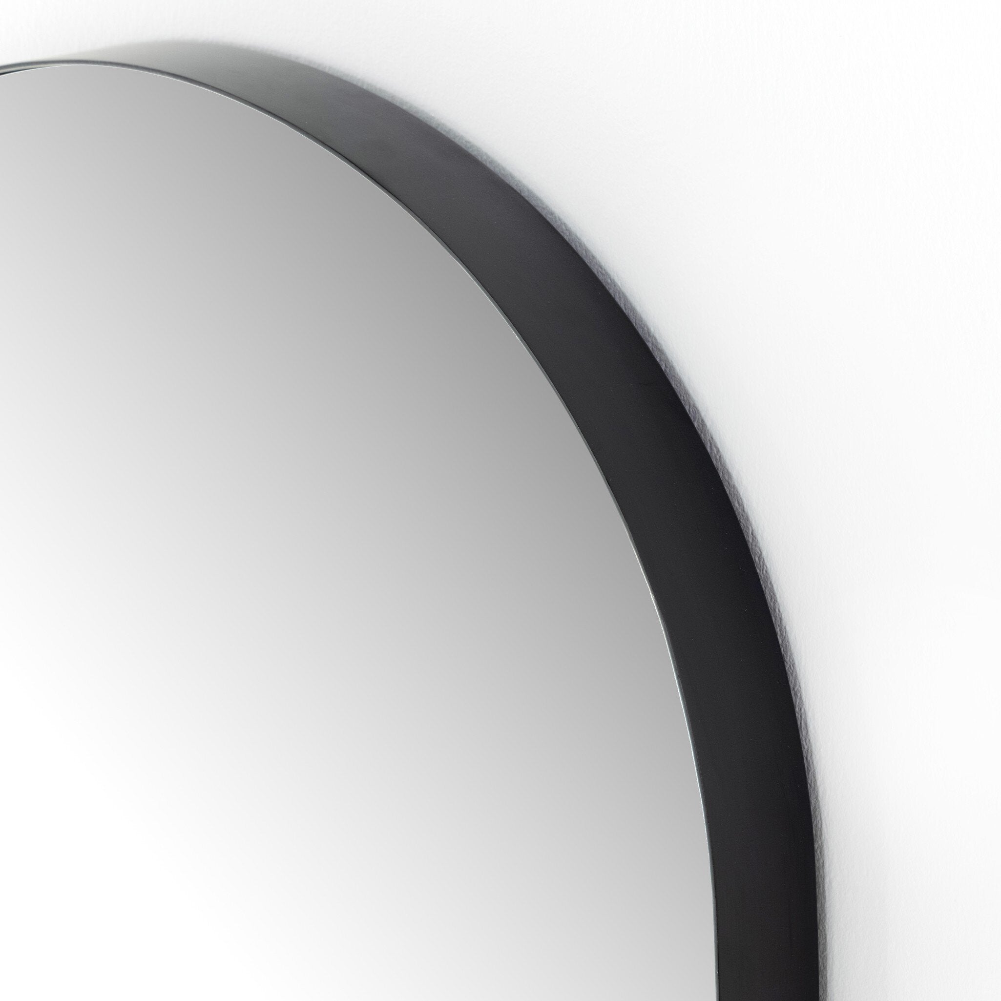 Textured view of the Georgina iron matte black arch mirror showcasing the thin industrial-style profile