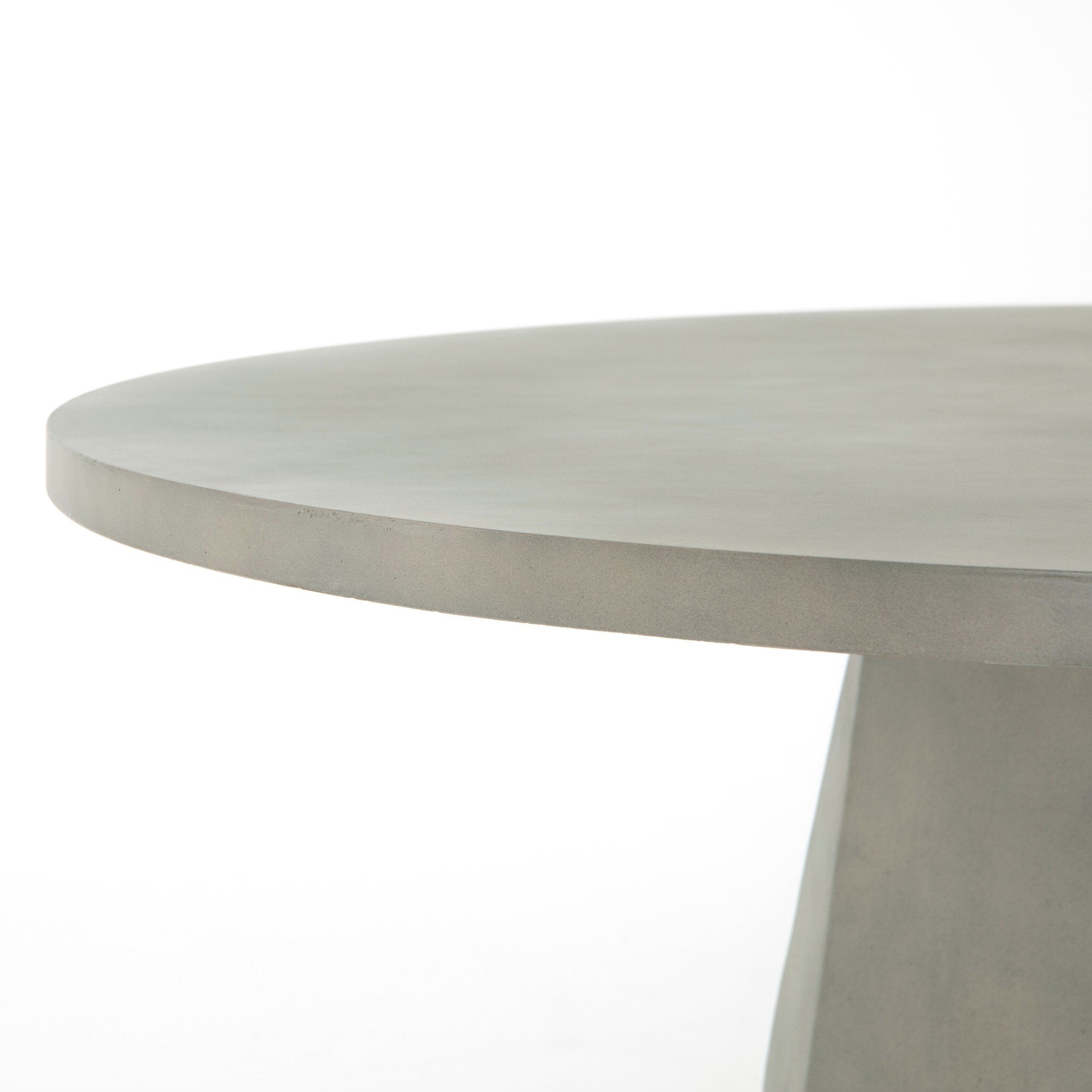 Top view Outdoor Dining Table with a round white concrete top and tapered pedestal base