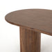 Top view Paden Dining Table in Seasoned Brown Acacia with crescent-shaped legs and an oval tabletop