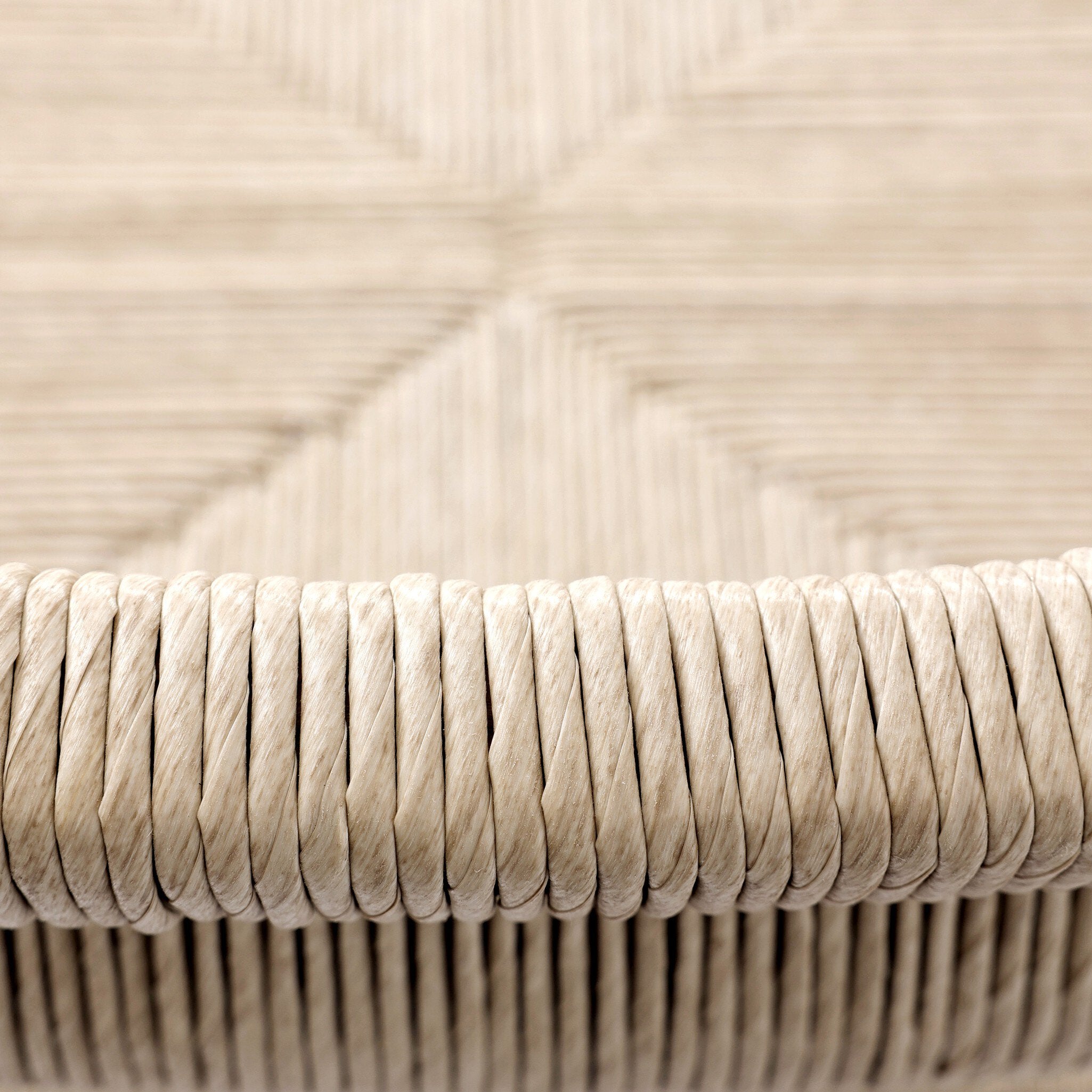 Outdoor bar stool seat detail with vintage white rope weave and rounded edge