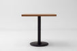 Rectangular red oak tabletop with black pedestal base
