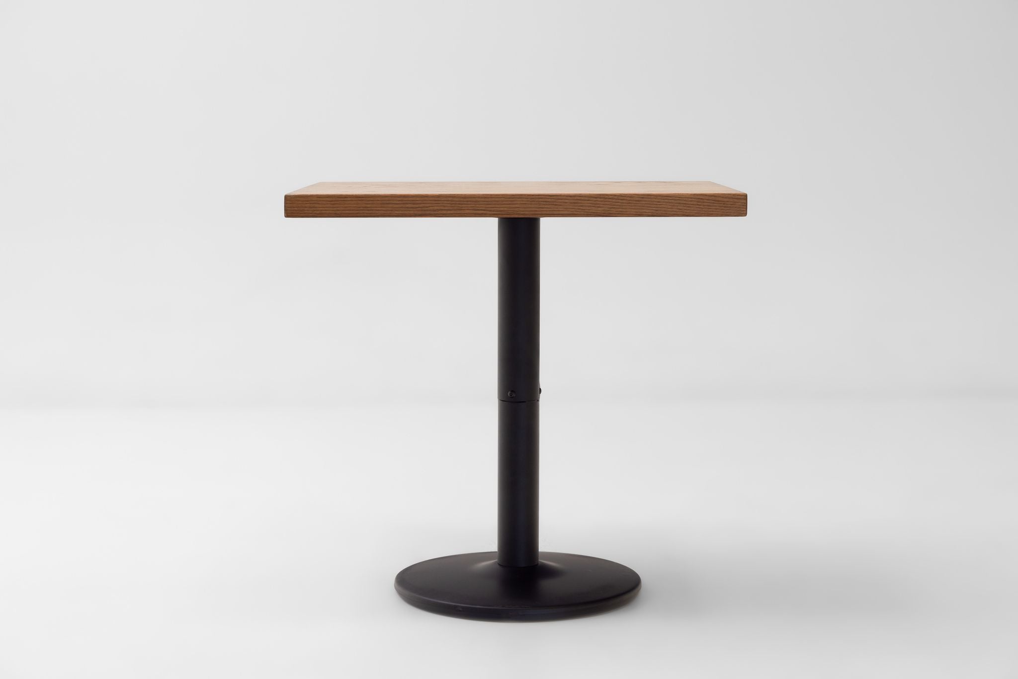 Rectangular red oak tabletop with black pedestal base