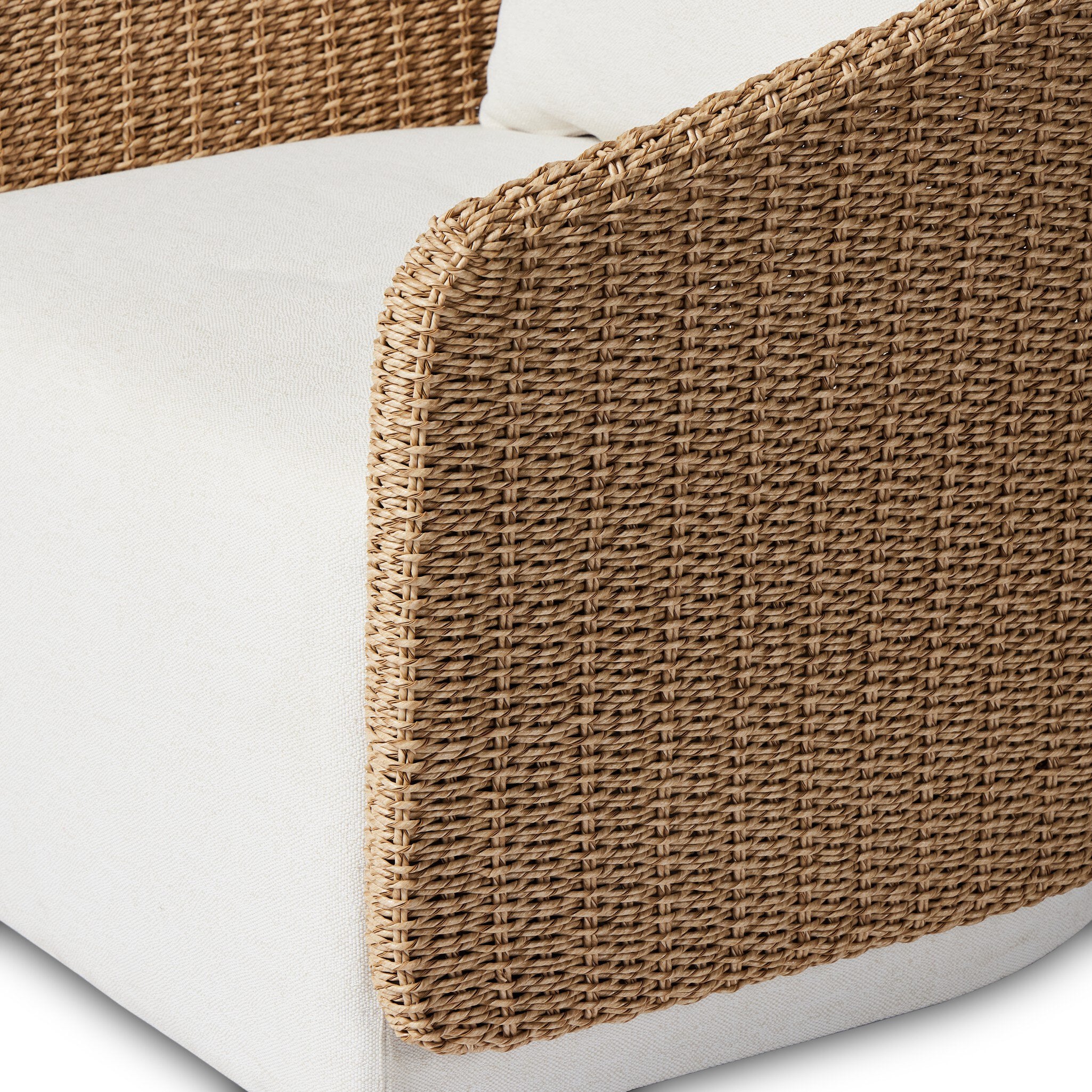 Wicker detailing Maven Outdoor Swivel Chair in Alessi Linen with a faux hyacinth woven shell and 360-degree base