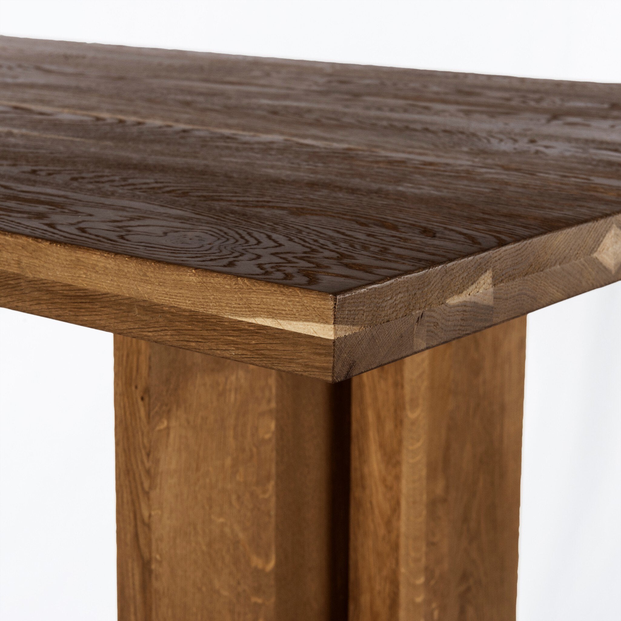 Wooden corner Erie Bar Table in Smoked Oak with a chunky pedestal base and modern rustic design