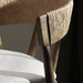 Bar stool back corner with woven rope panel and light seat cushion edge