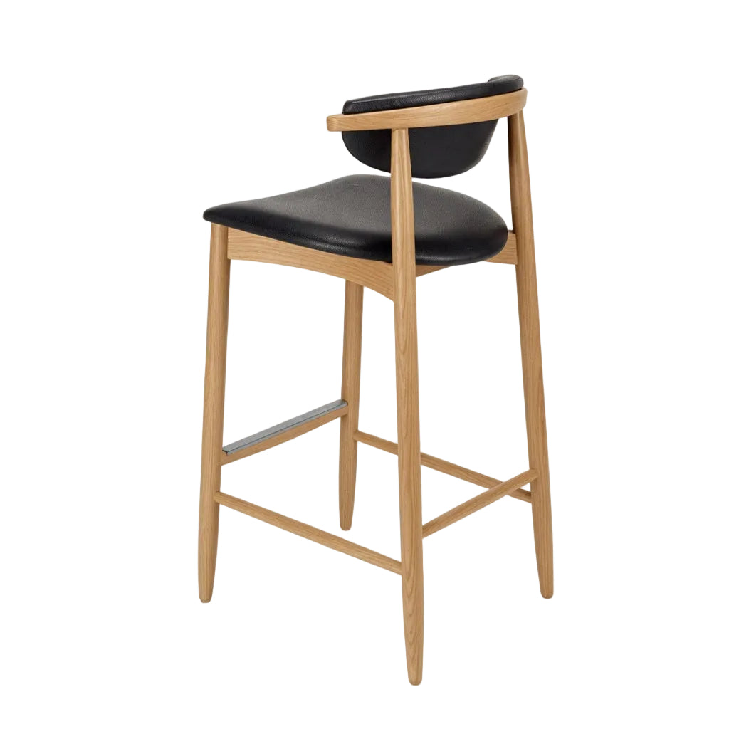 Bar stool with black upholstered seat and back, natural wood legs, crossbar footrest