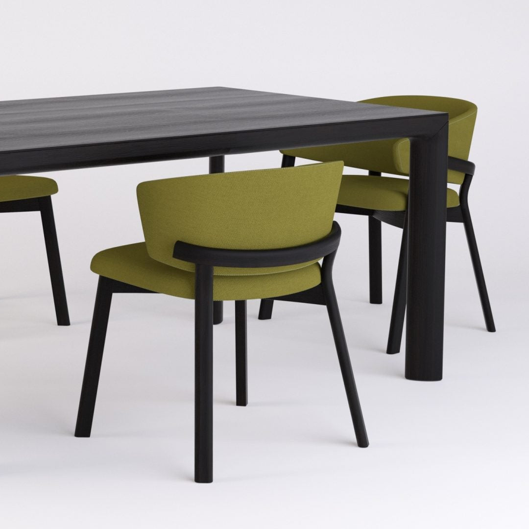 Editor side chair with green upholstered seat and backrest, black legs