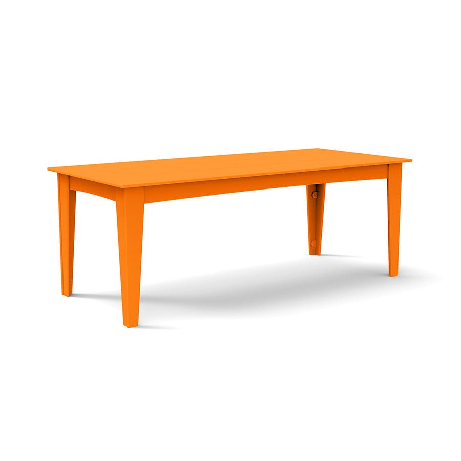 Alfresco dining table in sunset orange, 82 inches long with optional umbrella hole.