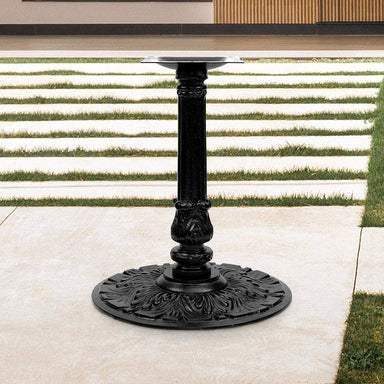 Decorative black metal pedestal base on a patio