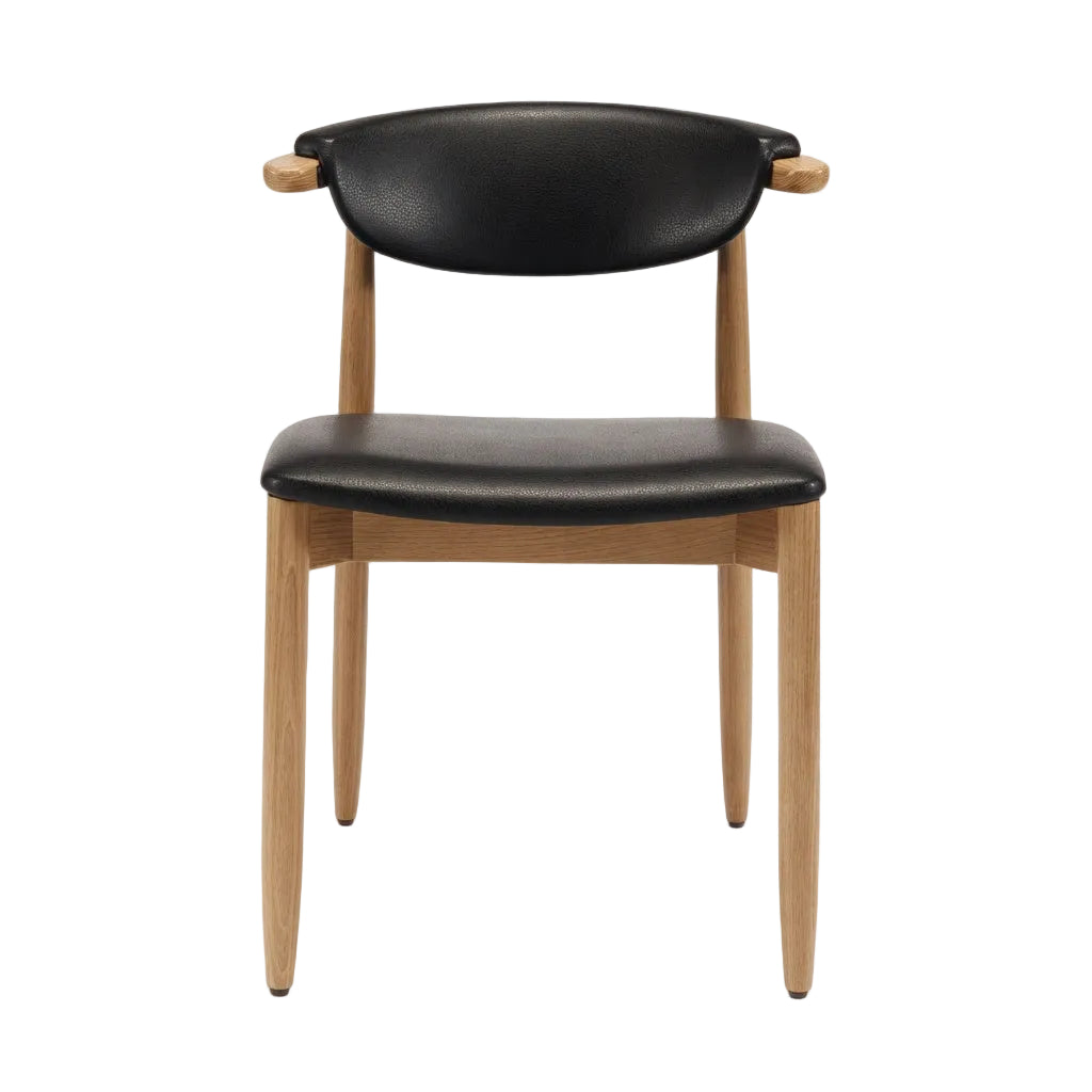 Natural wood side chair with black upholstered seat and rounded backrest, four tapered legs
