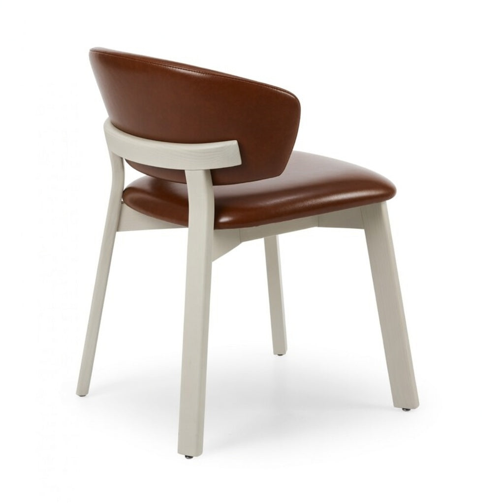 Editor side chair with brown upholstered seat and back, white frame and legs