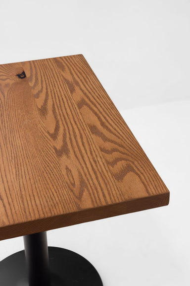 Red oak tabletop with visible wood grain and smooth beveled edge