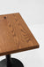 Red oak tabletop with visible wood grain and smooth beveled edge