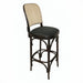 Theo bar stool side view with beige woven back, dark round seat, and curved footrest