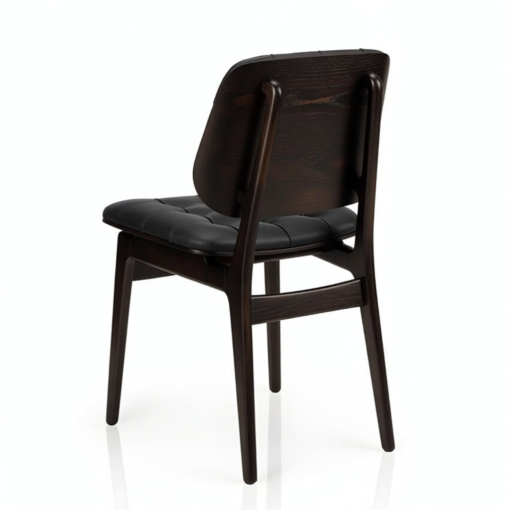 Sutton side chair with black padded seat and dark wood backrest, curved top panel