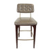 Upholstered bar stool with tufted back and beige seat, dark wood legs, gold underframe.