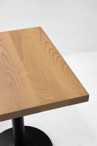 Ash table top with rounded corner and visible wood grain, natural light brown finish