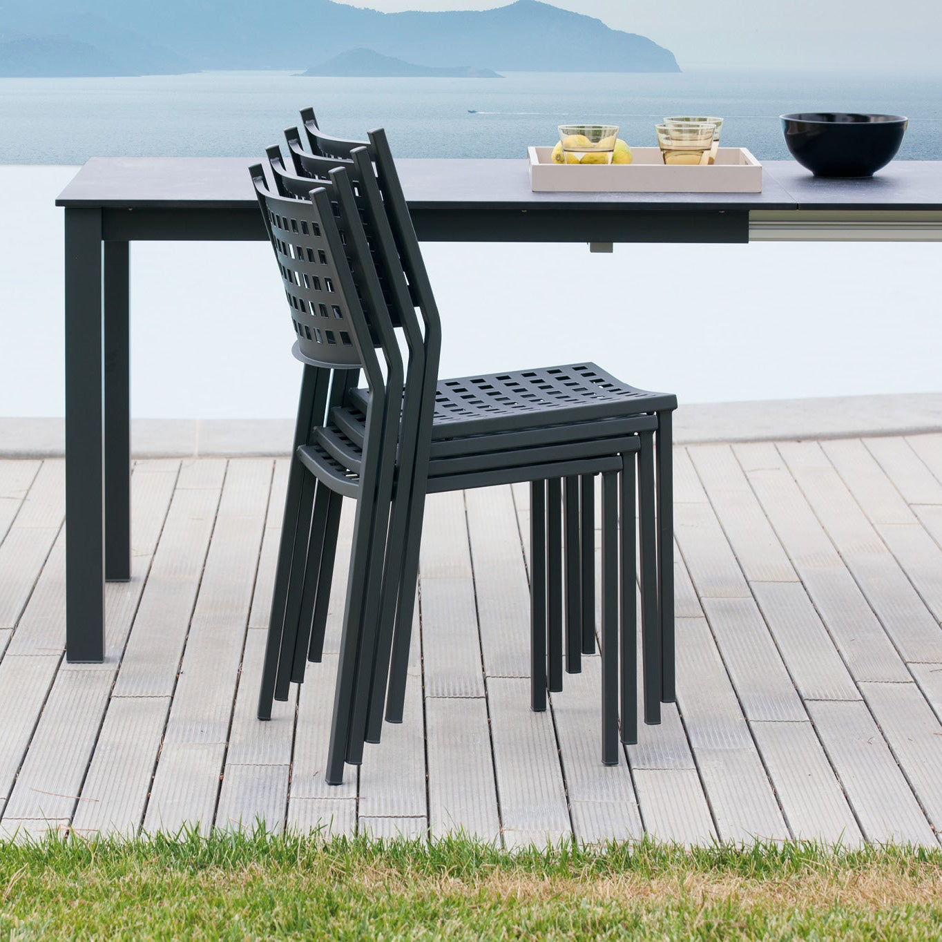 Zurich arm chair in dark gray with perforated back and seat, curved armrests