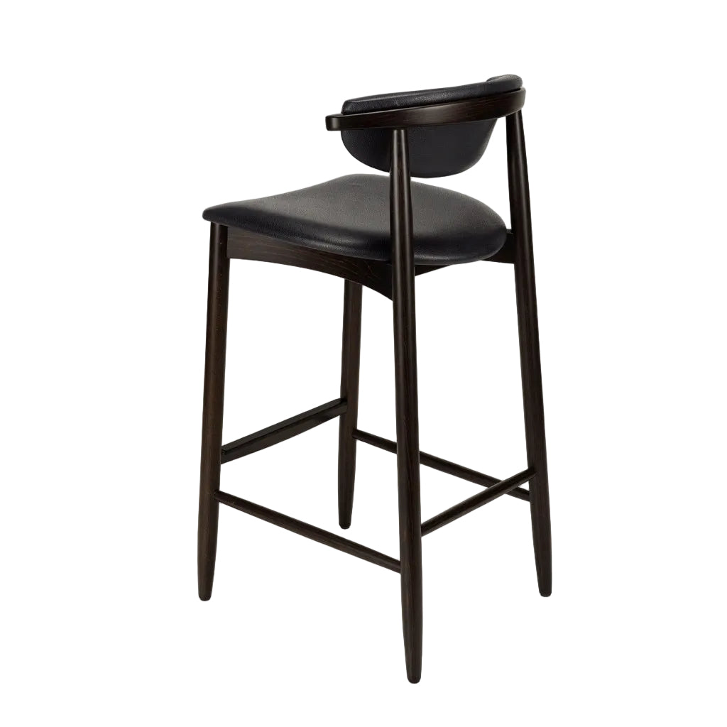 Bar stool with black upholstered seat and curved back, dark wood legs, footrest frame