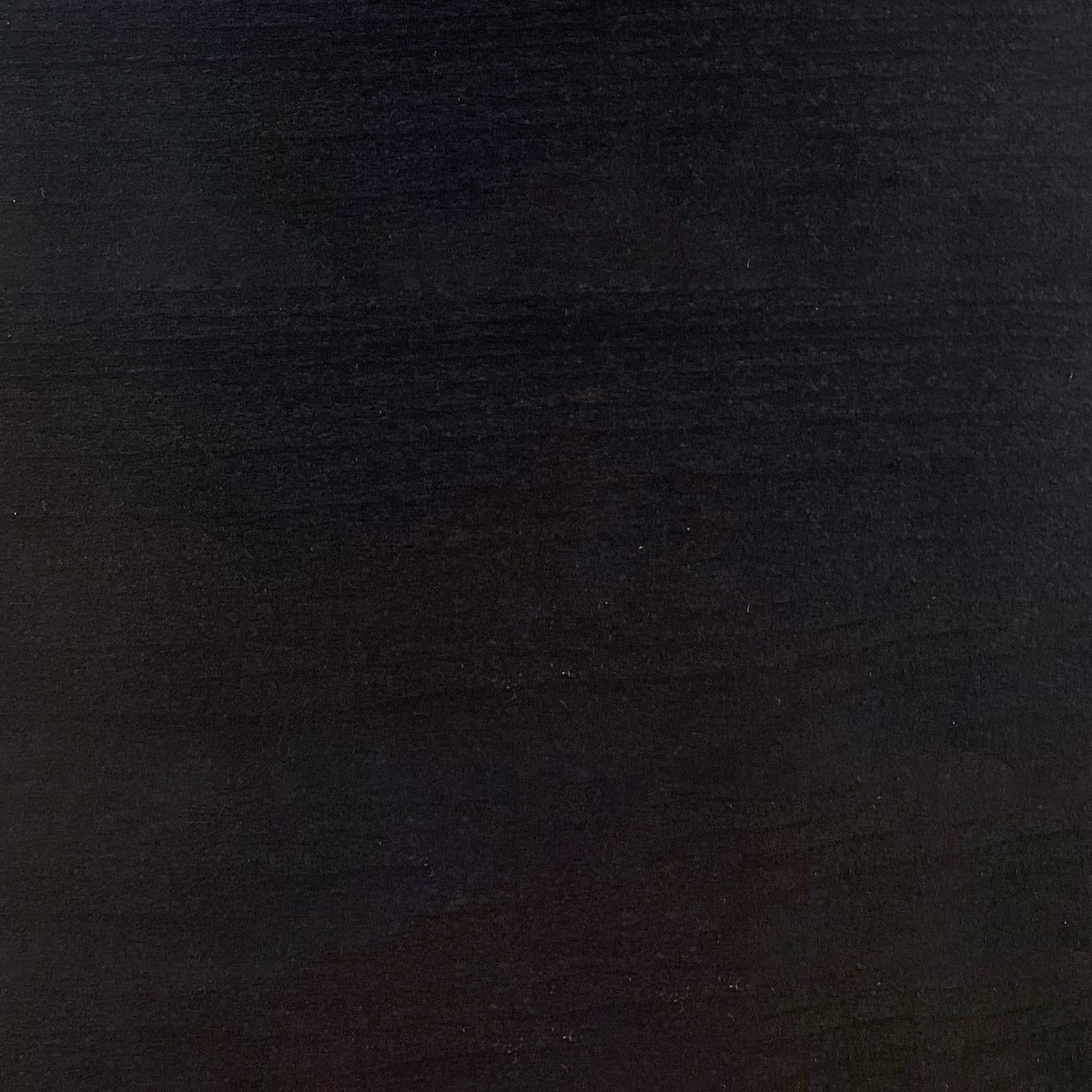 Upholstery finish swatch in dark charcoal with fine textured pattern
