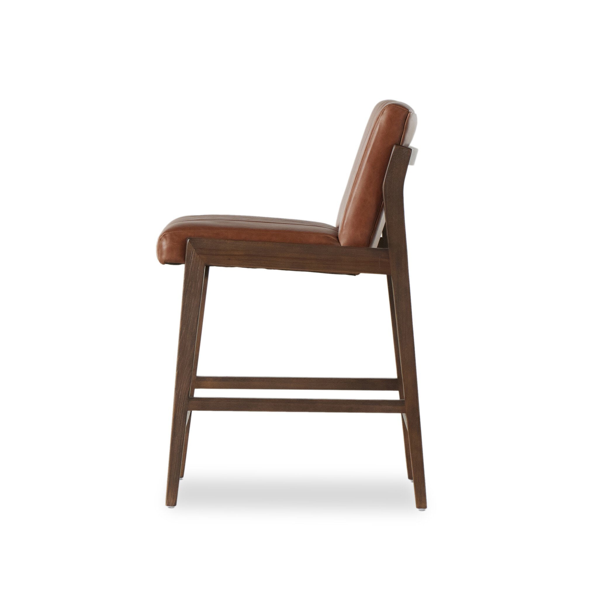 Brown upholstered counter stool with rounded seat and back, dark wood base, side view