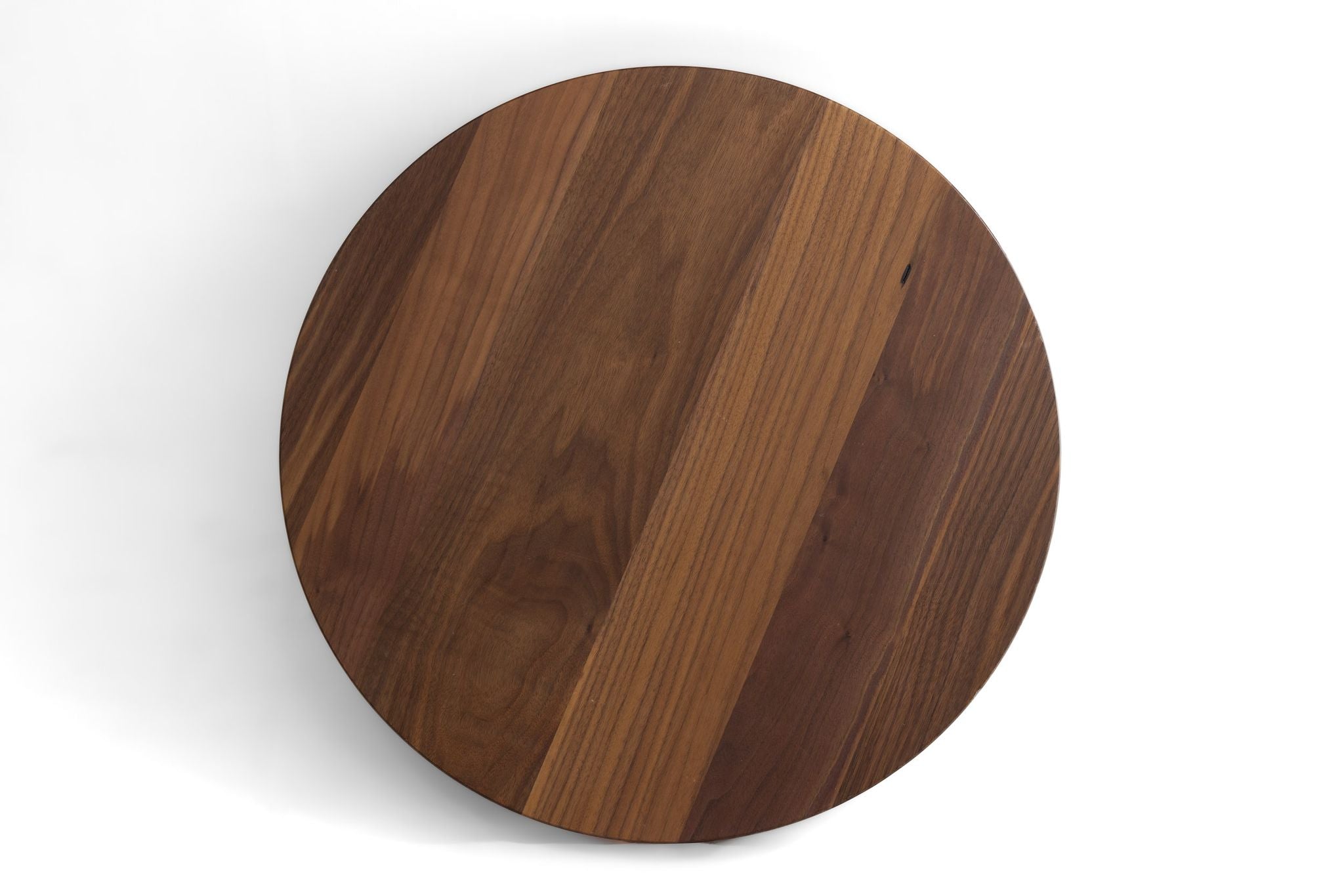 Round walnut table top with visible wood grain in a dark-brown finish.