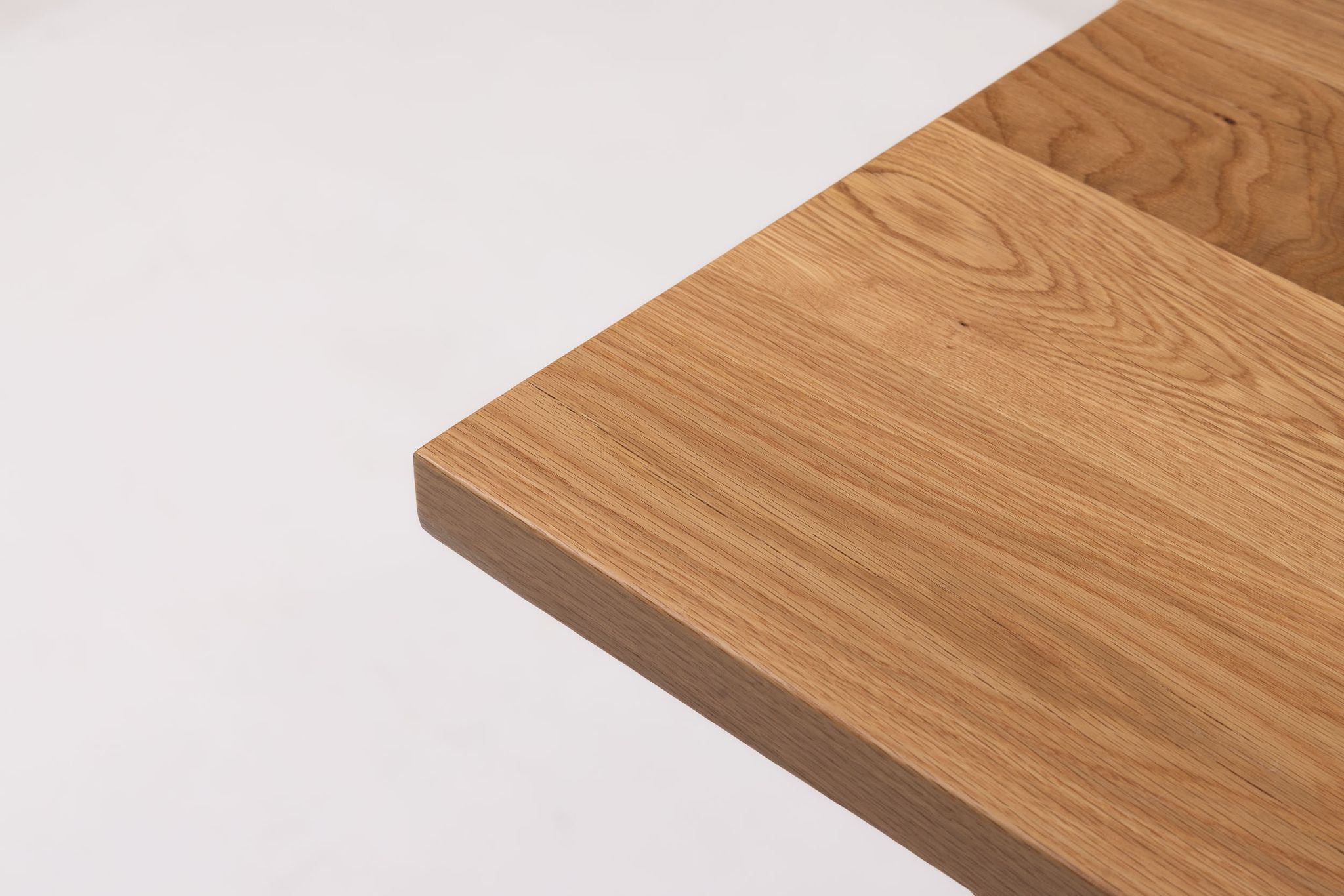 Corner view of white oak table top showing smooth rounded edge